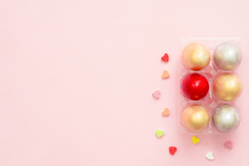 Flat lay top view colorful easter egg painted in pastel colors composition on pink pastel color background. Easter day background top view with copy space.