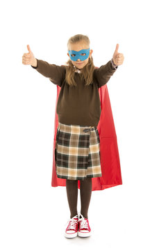7 or 8 years old young female child in super hero costume over school uniform  performing happy and excited isolated on white background