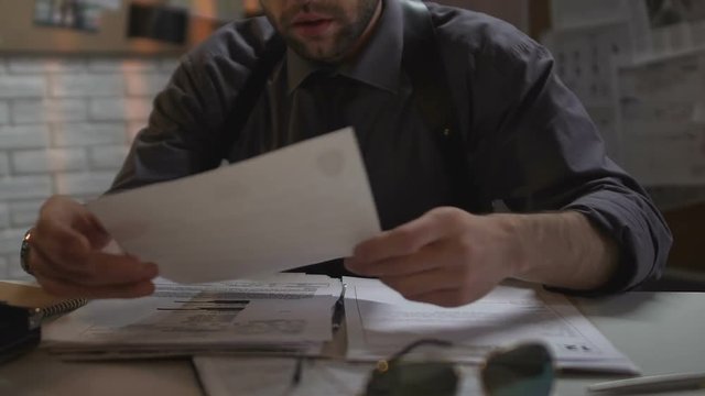 Female colleague bringing coffee for policeman working at case all night long