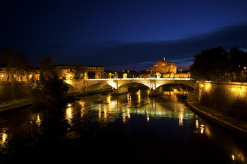Fototapeta na wymiar Roman Bridge over River at Night