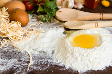 ingredients preparation spaghetti with eggs, tomatoes herbs and spices