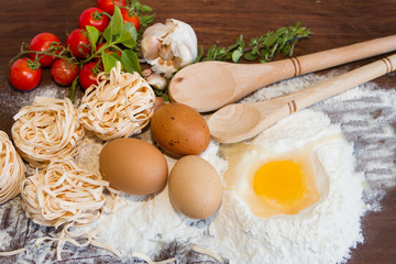 ingredients preparation spaghetti with eggs, tomatoes herbs and spices