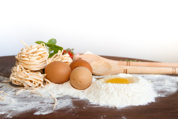 ingredients preparation spaghetti with eggs, tomatoes herbs and spices