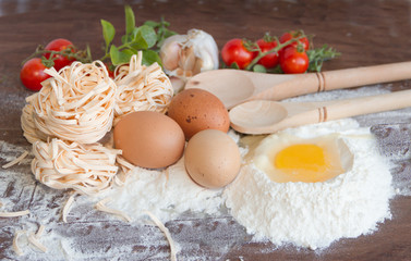 ingredients preparation spaghetti with eggs, tomatoes herbs and spices