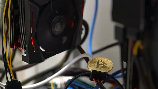 bitcoin on the background of a graphics card in a rack for crypto-currency mining