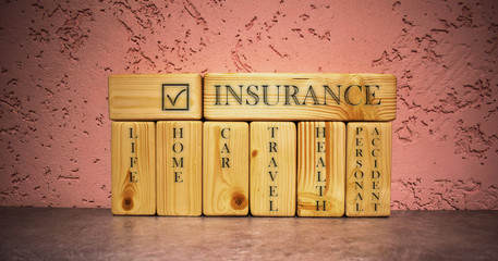 Business concept type of insurances on wood block with Words: Life Home Car Travel Health Personal Accident. Wooden blocks on pink background. Insurence concept.