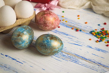 Easter Eggs, Sweets, White Fabric on the White Wooden Table