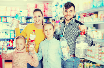 family holding bottled mineral water