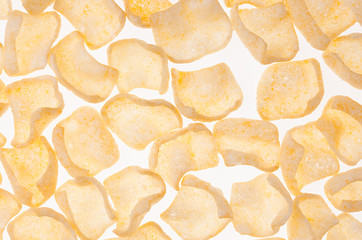 Flakes corn chips as pattern on white background, top view.