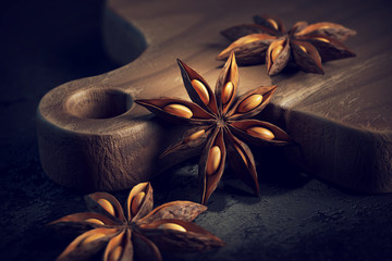 3d render of anice stars laying on a wooden cutting board