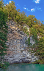 Fototapeta premium A rock by the blue lake. Abkhazia, near the lake Ritsa.