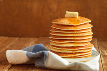 Stack of pancake with honey and butter on top