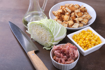 Fresh Chinese cabbage, Sweet canned corn, Delicious crispy croutons and canned tuna. Ingredients for dietary salad.