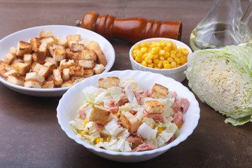 Fresh Chinese cabbage, Sweet canned corn, Delicious crispy croutons and canned tuna. Ingredients for dietary salad.
