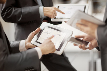 Hands of people working with tablet computer.