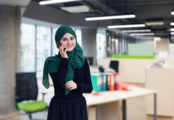 Muslim asian woman working in office with phone