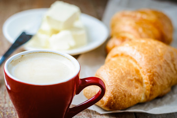 breakfast with cup of coffee and croissants with butter
