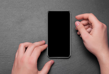 hand holding phone on black background clipping path inside.