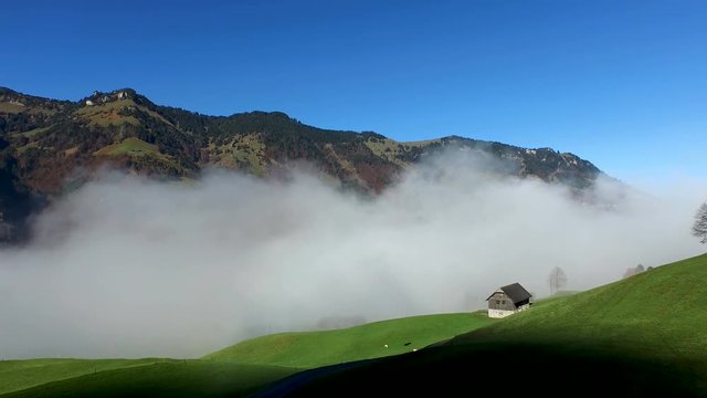 Aerial view in the valley of Engelberg in the foothills of Switzerland on an autumn day with a sea of fog