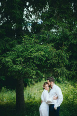 Fototapeta premium Romantic wedding moment, couple of newlyweds smiling portrait, bride and groom hug while on a walk in the park