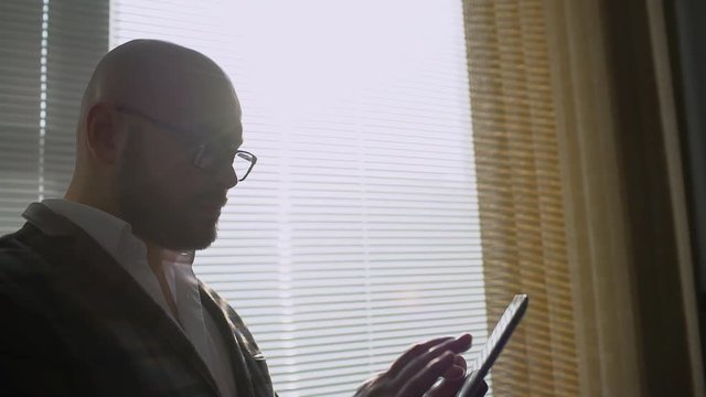 Man working in office with tablet. Business people developing a business project and analyzing market data information on a modern digital tablet computer. slow-motion