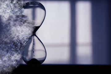 Hourglass as time passing and pass away concept.