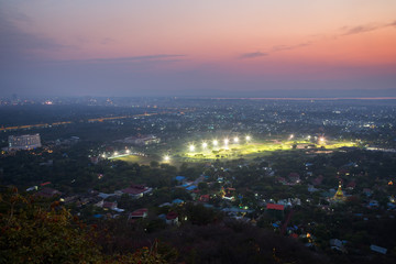 City of Mandalay in Myanmar (Burma), viewed from above from the Mandalay Hill in the evening.