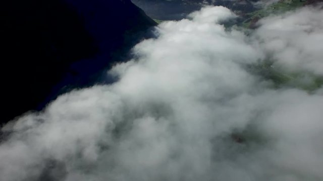 Aerial view in the valley of Engelberg in the foothills of Switzerland on an autumn day with a sea of fog