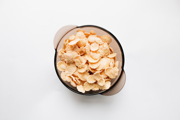 delicious crispy cornflakes in bowl on white background,  healthy breakfast