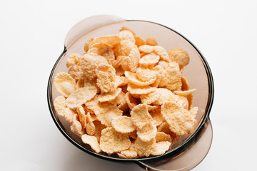 delicious crispy cornflakes in bowl on white background,  healthy breakfast