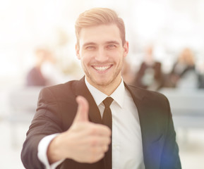 portrait of happy businessman showing thumb up.