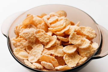 delicious crispy cornflakes in bowl on white background,  healthy breakfast
