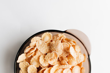 delicious crispy cornflakes in bowl on white background,  healthy breakfast