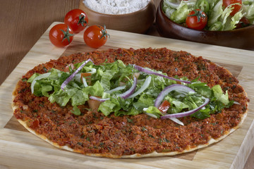 Turkish Food: lahmacun closeup on a wooden table. Horizontal
