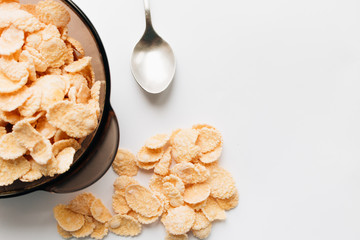 delicious crispy cornflakes in bowl on white background,  healthy breakfast