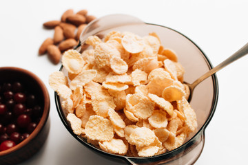 Delicious crispy cornflakes in bowl on white background, healthy breakfast