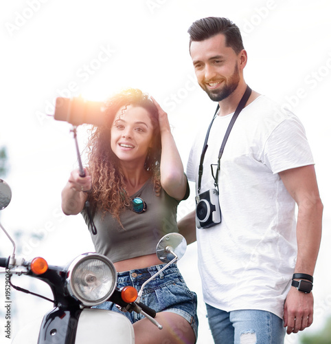 Male And Female On Motor Scooters In A Town Male And Female On Motor Scooters In A Town