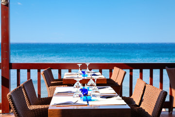 Fototapeta premium The open air restaurant by the sea is ready to receive visitors.