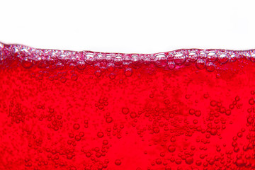 red soda water splashing  with bubbles close up and Dew Point on glass
