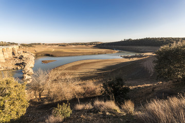 The Ricobayo reservoir (Embalse de Ricobayo) and the Puente de la Estrella arch bridge over the...
