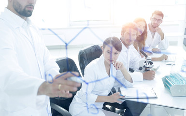 Obraz premium from behind the glass. a scientist standing near the blackboard 