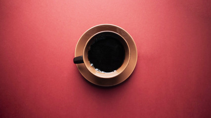 Top view of female hand holding cup of coffee