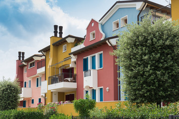 Fototapeta na wymiar A modern, colorful block of flats in a tiny town in Italy
