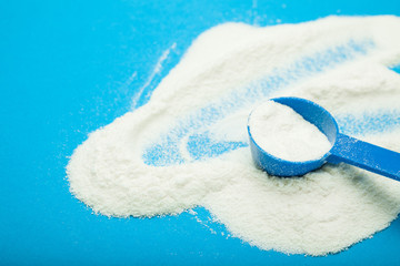 Sprayed powdered milk on a blue background.