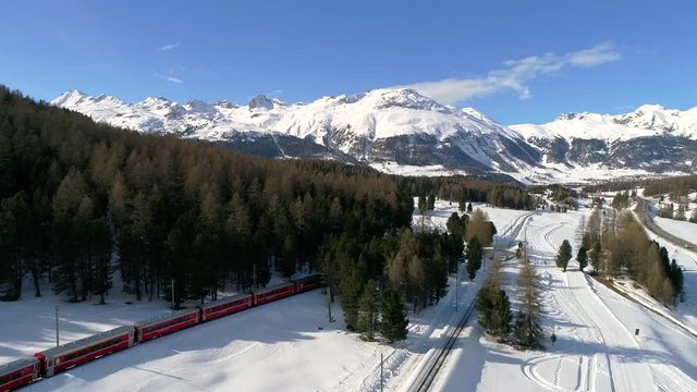 Bernina Express, red train of Bernina in Engadine. Aerial view in the winter season.
Engadine (CH) Winter 2018