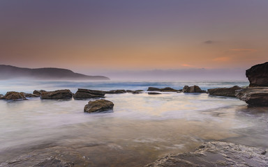 Hazy Dawn Seascape with Rocks