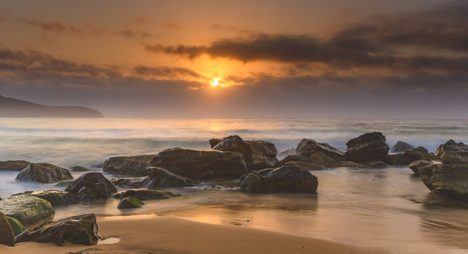 Hazy Sunrise Seascape with Rocks