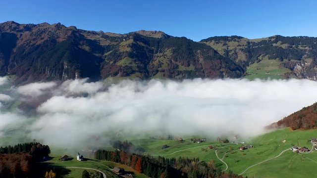 Aerial view in the valley of Engelberg in the foothills of Switzerland on an autumn day with a sea of fog