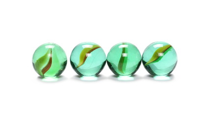 Pile of green glass marbles, isolated on white background