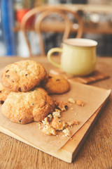 Sweet cookies with chocolate pieces served with coffee